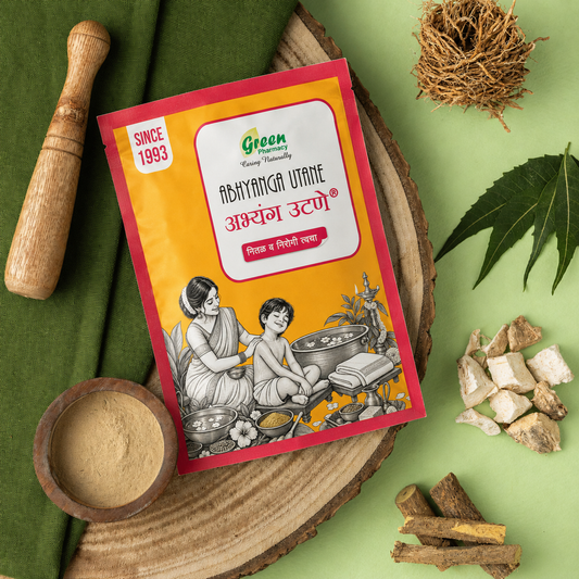 A packet of Green Easy Natural Abhyang Otone herbal paste is displayed on a styled flat-lay background with traditional ingredients including a wooden pestle, a bowl of powder, amharica leaves, and roots on a light green surface.