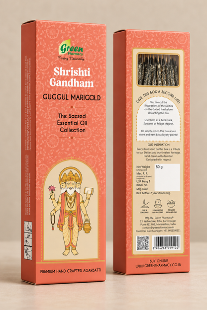 Two standing product boxes for Shrishti Gandham Guccul Marigold essential oil on a plain beige background. The front box shows the brand Green Pharmacy, the product name, and an illustration of a Hindu deity.