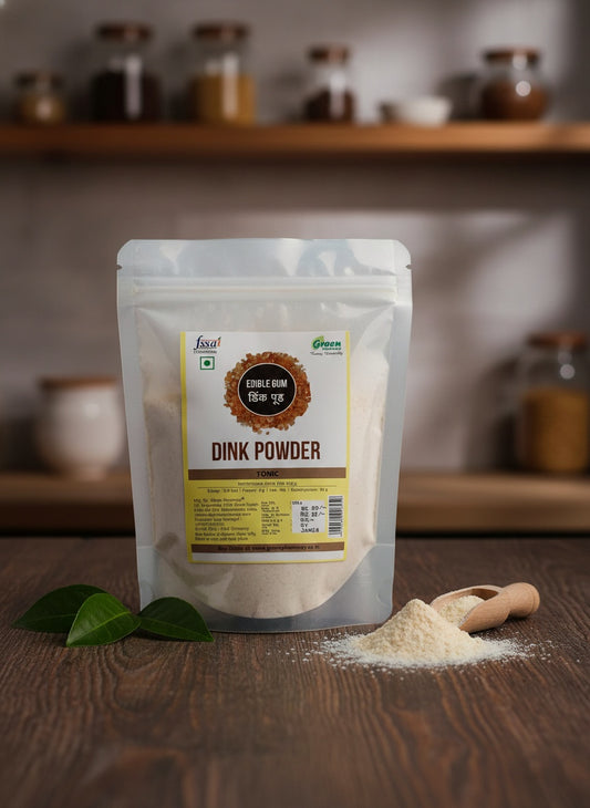 Packaging of Dink Powder with a scoop and leaves on a wooden surface