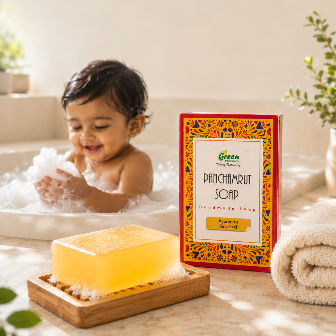 A child playing in a bubble bath next to a boxed bar of Green Patchamrut Soap, with a yellow soap bar on a wooden tray in the foreground.