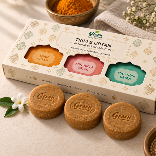 Green Pharmacy Triple Ubtan body bath set, featuring a cream-colored box with three colorful window cutouts showing orange, pink, and teal bars, alongside three round brown Ubtan bars placed in front on a beige fabric surface with botanical props.