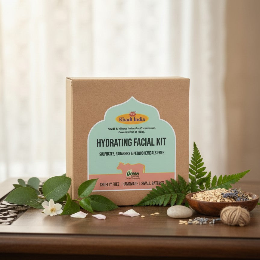 Khadi India hydrating facial kit on a wooden surface with green leaves and a white curtain background