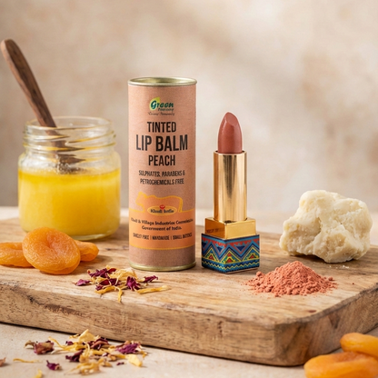 Tinted lip balm, jar of juice, and other items on a wooden surface with a neutral background